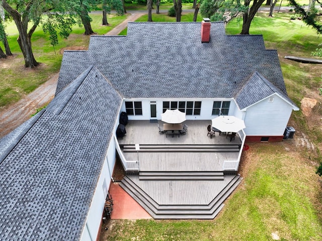 back of house with a shingled roof, a chimney, central AC, and a deck