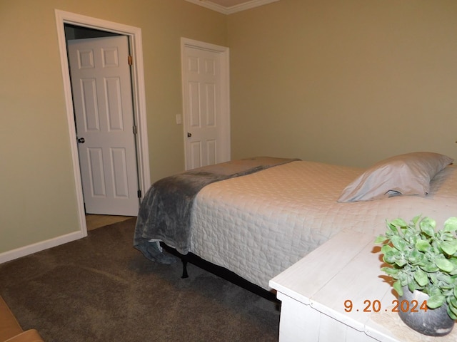 bedroom with crown molding and carpet flooring