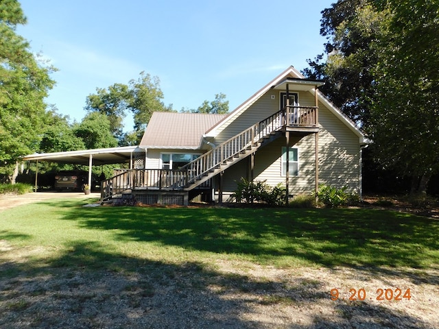 rear view of house with a carport and a yard