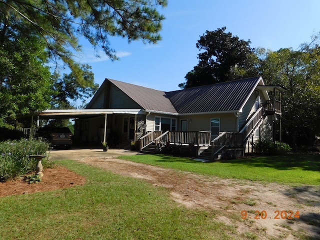 rear view of property with a lawn and a carport