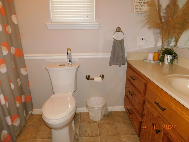 bathroom featuring vanity, tile patterned flooring, and toilet