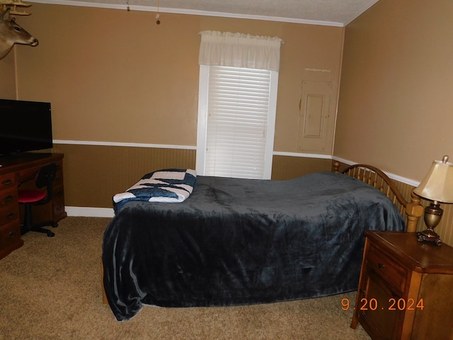 bedroom with ornamental molding and light carpet