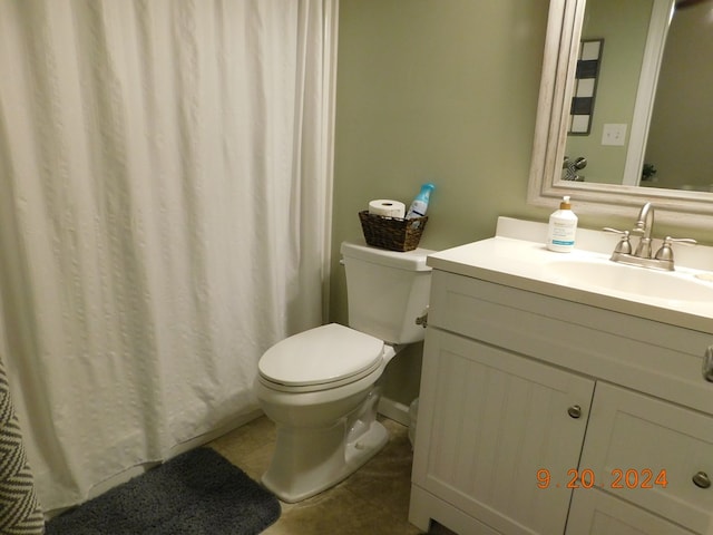 bathroom featuring vanity, tile patterned floors, and toilet