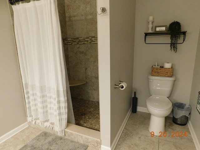 bathroom featuring tile patterned flooring, toilet, and a shower with curtain