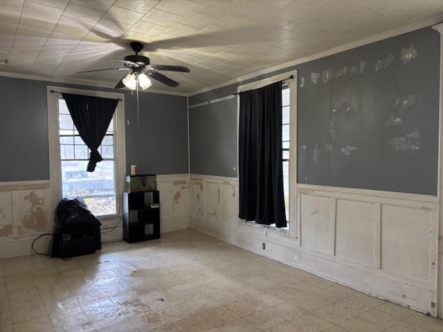 spare room featuring crown molding and ceiling fan