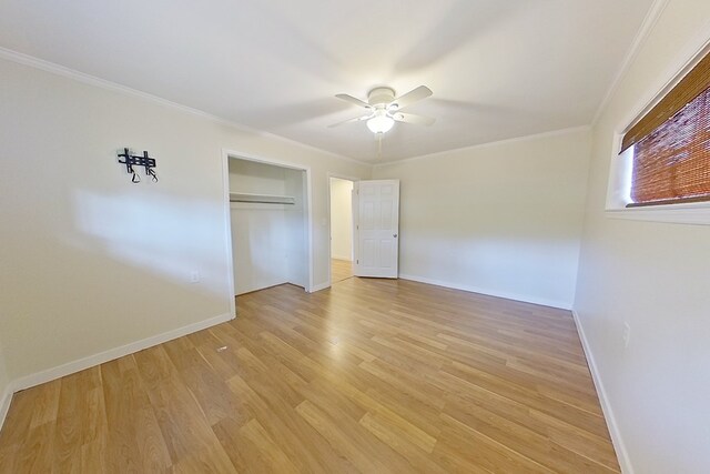 unfurnished bedroom with ornamental molding, a closet, ceiling fan, and light wood-type flooring