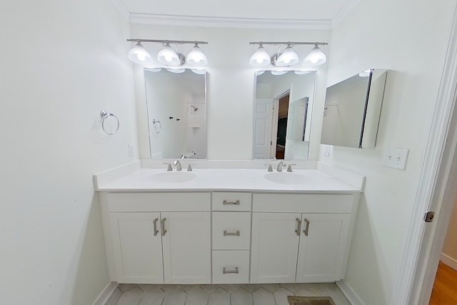 bathroom with ornamental molding and vanity