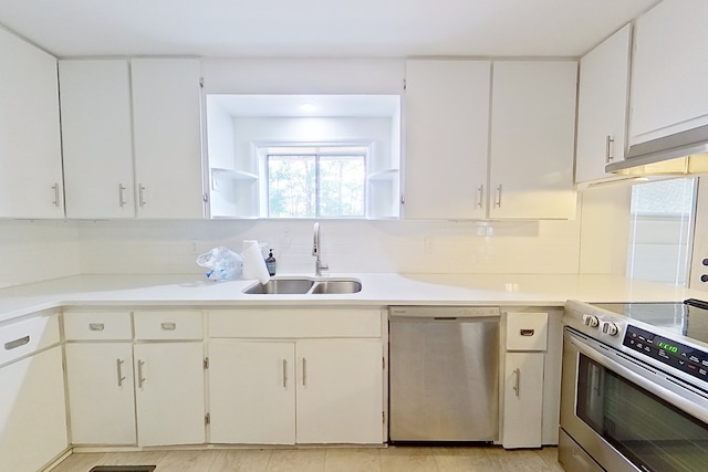 kitchen with white cabinetry, stainless steel appliances, and sink