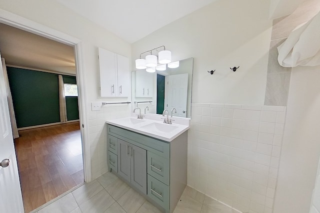 bathroom featuring tile patterned flooring, vanity, and tile walls