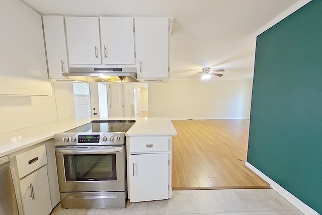 kitchen with ceiling fan, stainless steel appliances, white cabinets, decorative backsplash, and light wood-type flooring