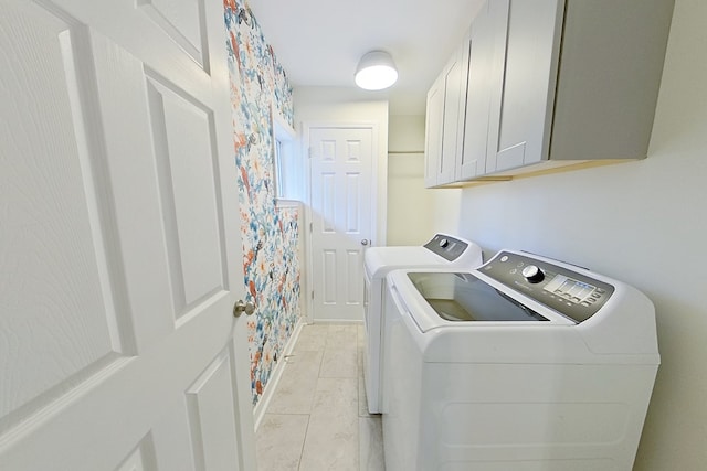 laundry room featuring cabinets and washing machine and dryer