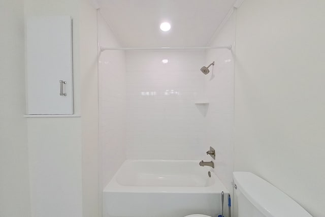 bathroom featuring tiled shower / bath and toilet