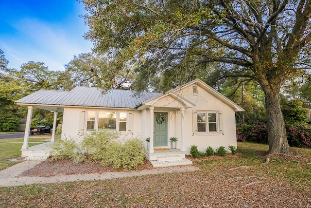 view of front of property with metal roof and a carport