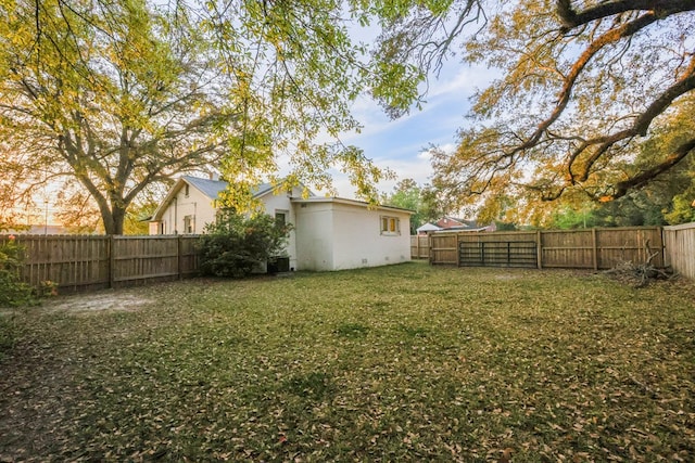 view of yard featuring central air condition unit and a fenced backyard