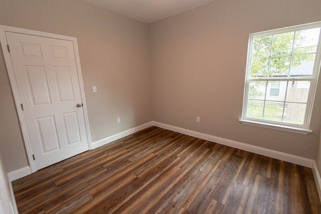 unfurnished room featuring dark hardwood / wood-style floors