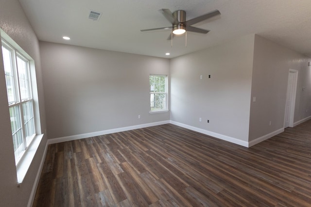 spare room with dark hardwood / wood-style floors and ceiling fan