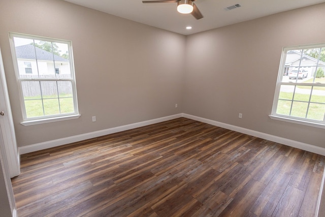 empty room with dark wood-type flooring and ceiling fan