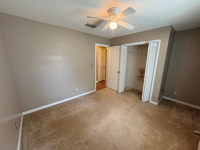 102 Spruce Pine Dr, Thomasville, GA 31757 - unfurnished bedroom with carpet flooring, a closet, a ceiling fan, and a textured ceiling