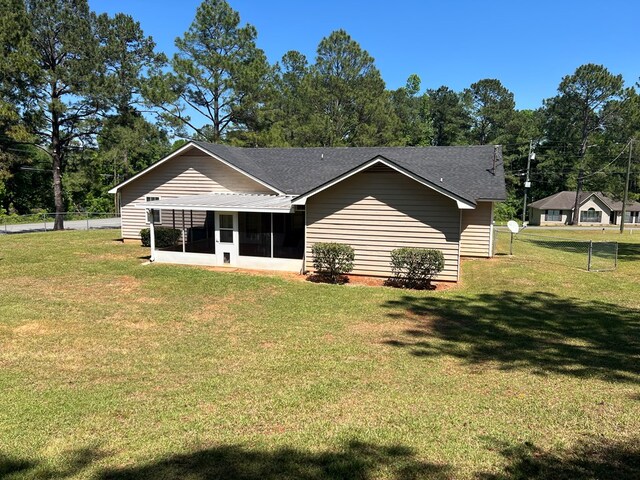 102 Spruce Pine Dr, Thomasville, GA 31757 - back of house featuring a sunroom and a shingled roof