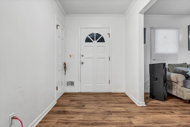 foyer entrance featuring ornamental molding and hardwood / wood-style floors