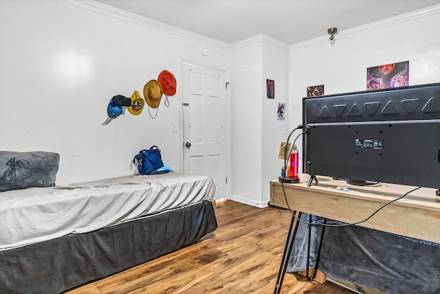 bedroom featuring ornamental molding and wood-type flooring