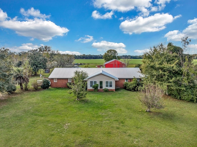 exterior space with a front yard and a rural view