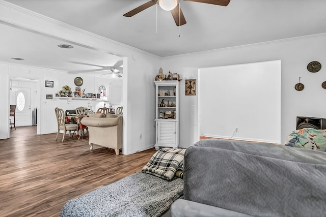 living room featuring dark hardwood / wood-style flooring, ornamental molding, and ceiling fan