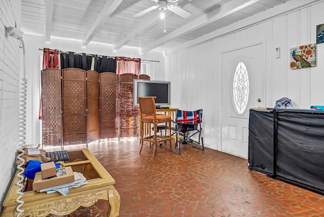 interior space with beamed ceiling and ceiling fan