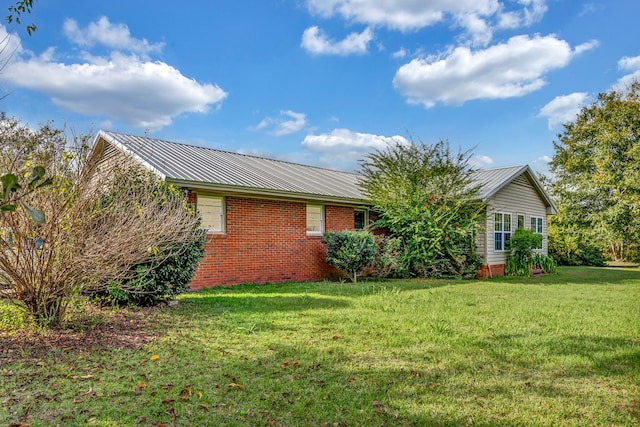 rear view of house featuring a lawn