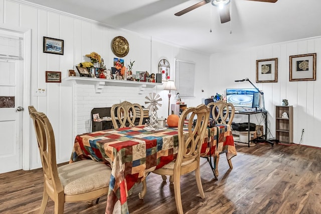 dining space with crown molding, dark wood-type flooring, and ceiling fan