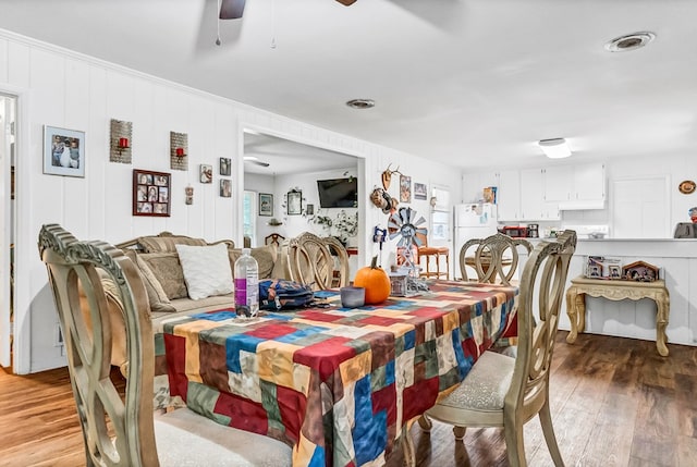 dining area with hardwood / wood-style flooring and ceiling fan