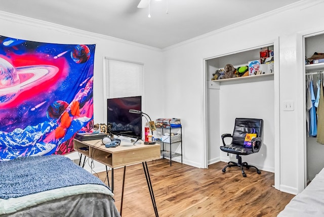 bedroom with wood-type flooring, ornamental molding, and ceiling fan