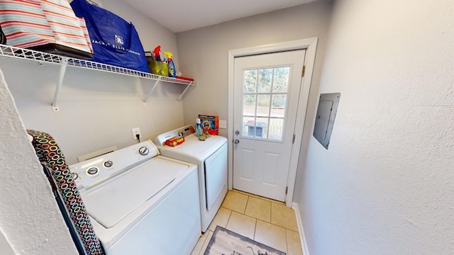 laundry area featuring light tile patterned flooring, separate washer and dryer, and electric panel