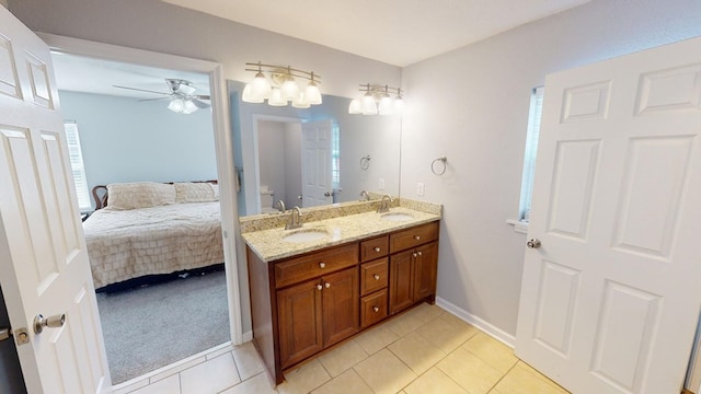 bathroom featuring vanity, plenty of natural light, tile patterned floors, and toilet