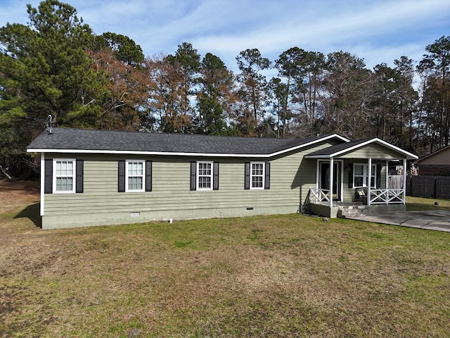 manufactured / mobile home with covered porch and a front lawn