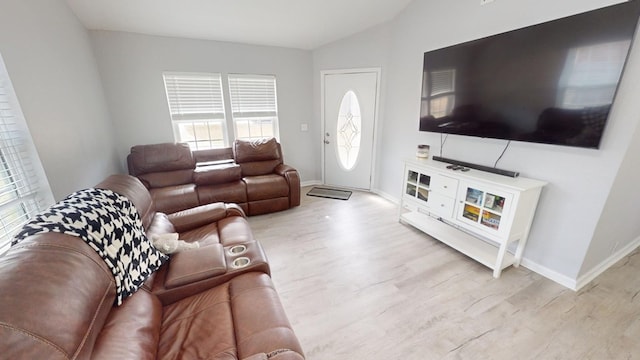 living room with lofted ceiling and light wood-type flooring