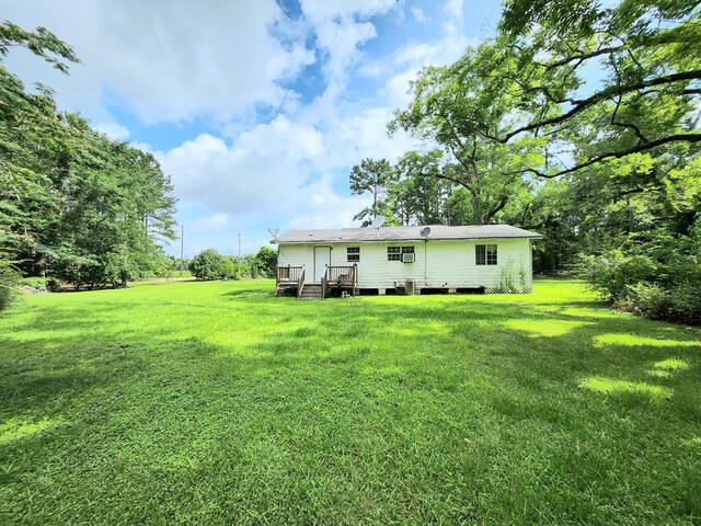 3812 Ponder Rd, Thomasville, GA 31757 - rear view of property with a yard and a wooden deck