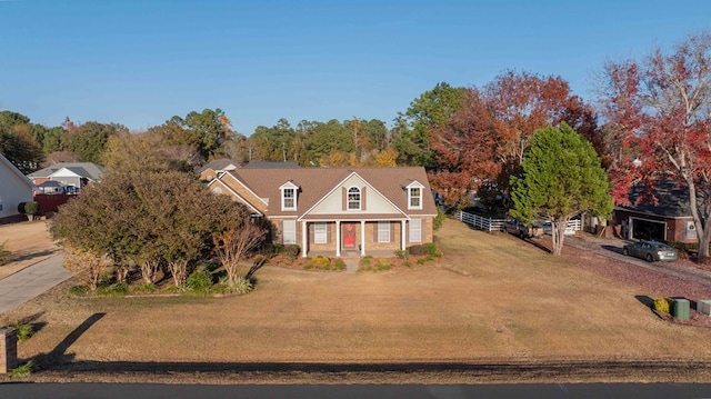 cape cod house with covered porch and a front lawn