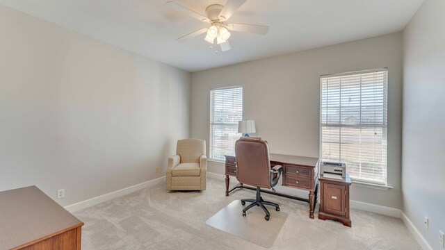 carpeted home office with plenty of natural light and ceiling fan