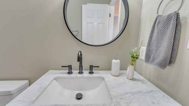 bathroom featuring vanity and toilet