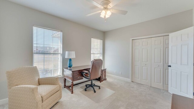 carpeted home office with ceiling fan