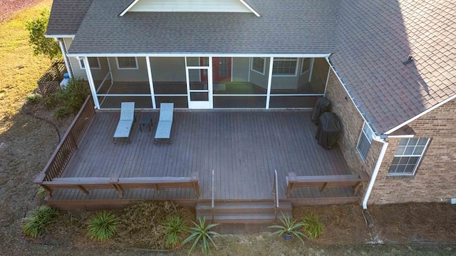 back of house with a sunroom and a deck