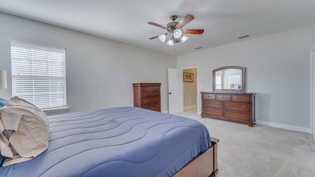 bedroom with ceiling fan and light colored carpet