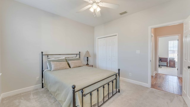 carpeted bedroom featuring ceiling fan and a closet