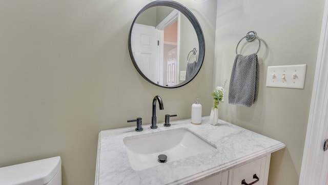 bathroom featuring vanity and toilet