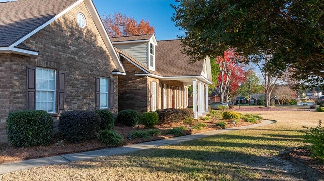 view of side of property with a yard