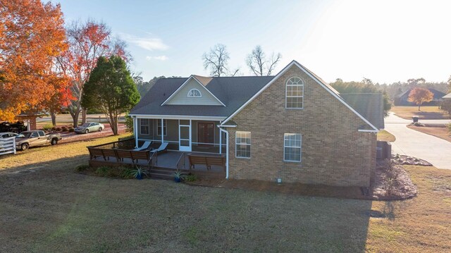 view of front facade with a front lawn and a sunroom