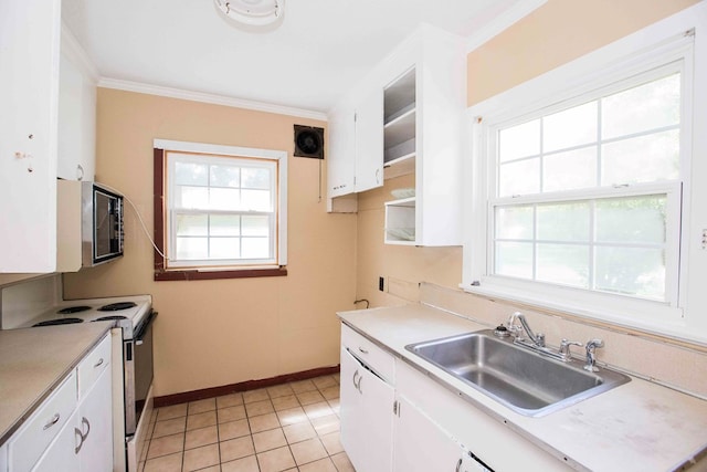 kitchen with crown molding, stainless steel microwave, a sink, white cabinets, and range with electric cooktop