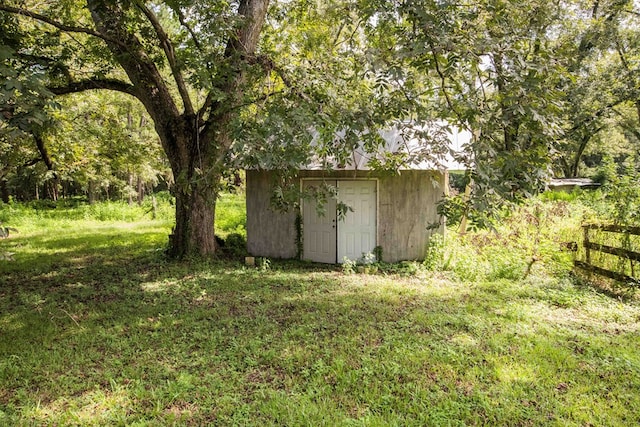 view of shed featuring fence