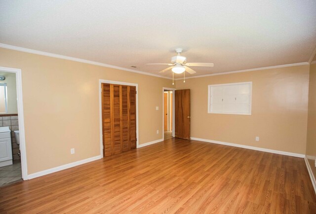 unfurnished room featuring a ceiling fan, light wood-style flooring, ornamental molding, and baseboards
